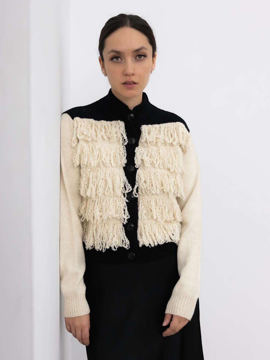 button up alpaca fringed cardigan white with black rib on a model with a white background