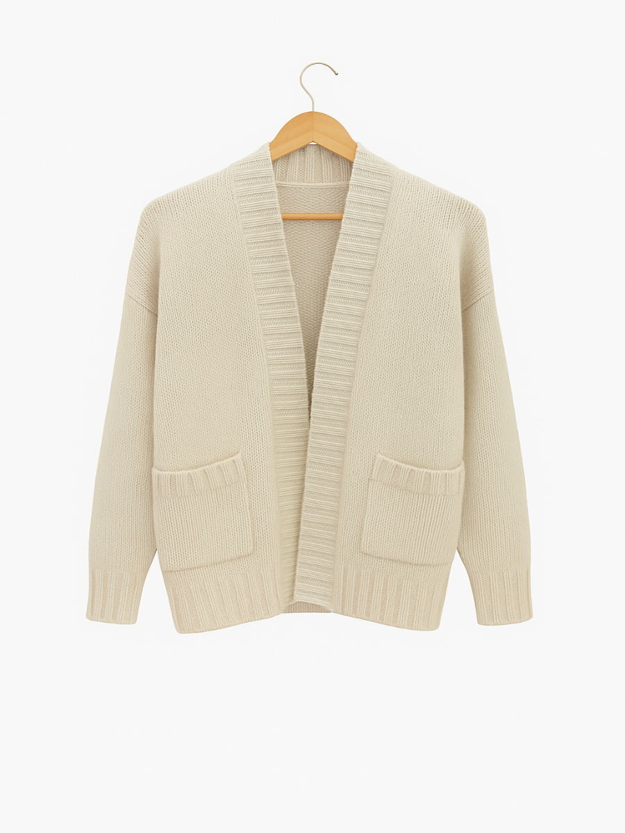 Beige cardigan on a wooden hanger against a white background