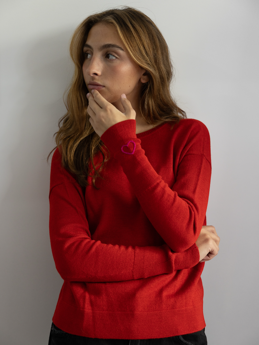red Alpaca Basic V neck sweater with a hand embroidered heart in the sleeve.