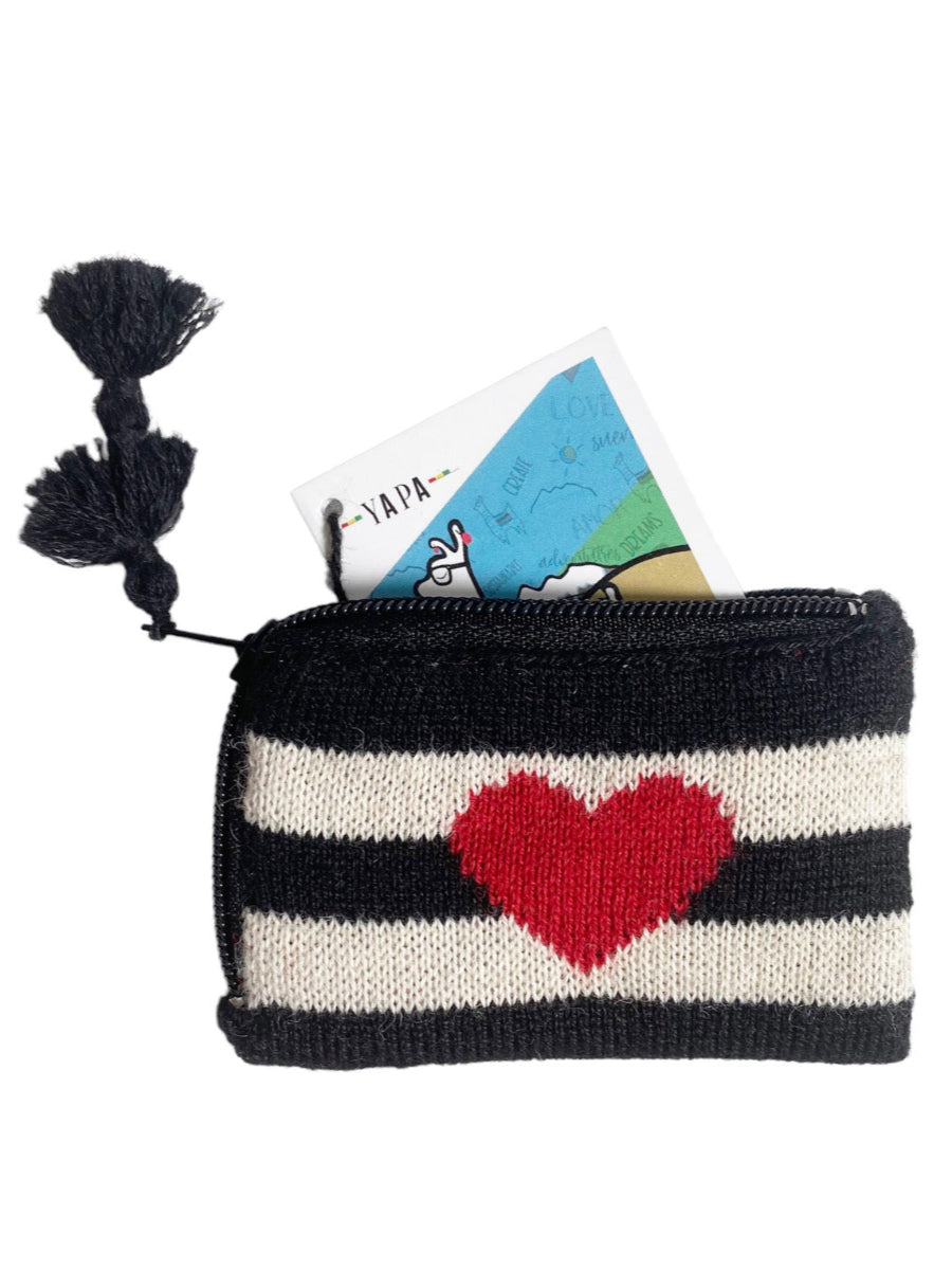 Black-and-white striped alpaca coin purse featuring a red heart motif on the front, finished with a zipper closure and tassel detail, shown against a plain background.