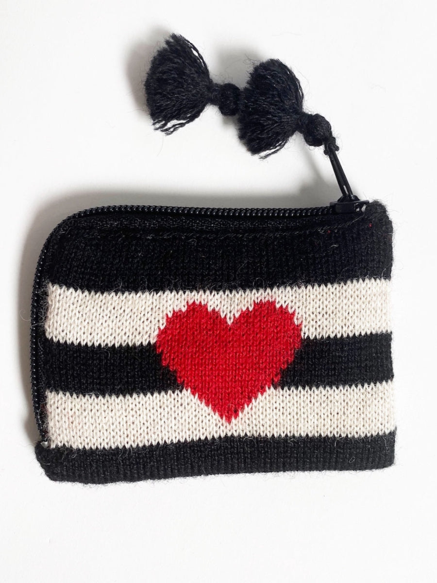 Black-and-white striped alpaca coin purse featuring a red heart motif on the front, finished with a zipper closure and tassel detail, shown against a plain background.