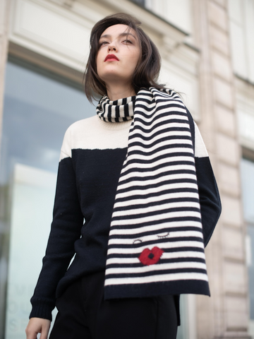 Mia zebra alpaca wool stripped scarf with a kiss design on a model wearing a black and whit color clock sweater