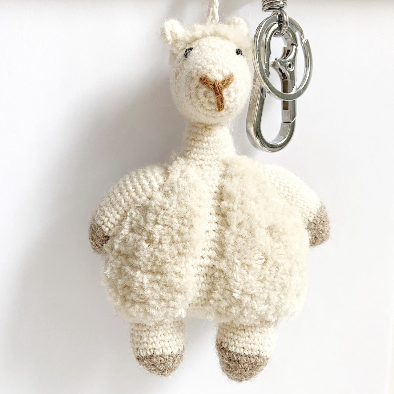 crochet knitted alpaca bag charm with white background