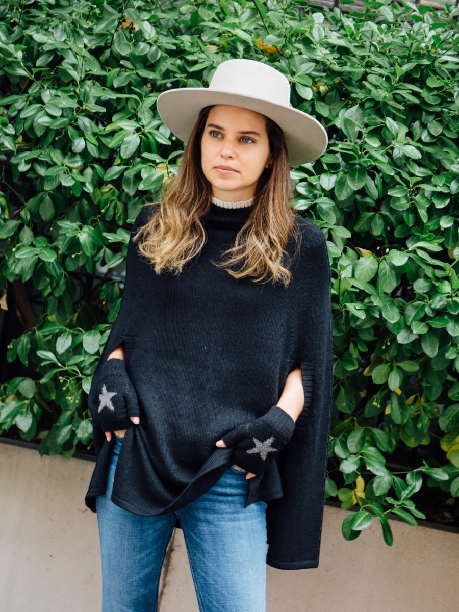 baby alpaca black poncho cape with star mittens on a model on city street