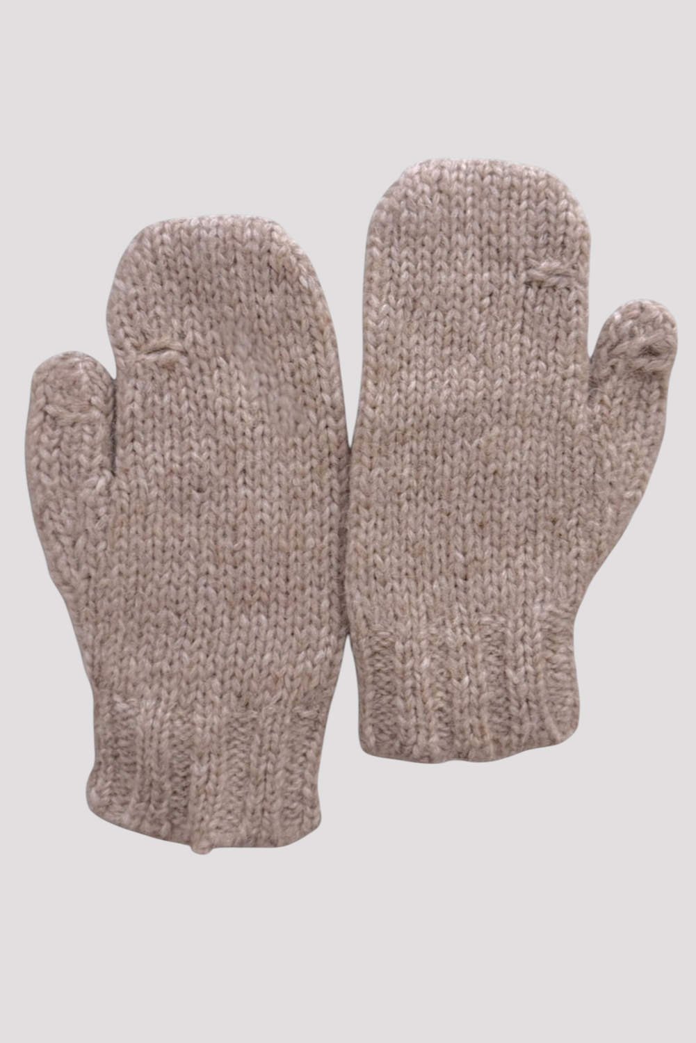 A pair of chunky knit fingerless mittens in a heathered taupe-beige color, displayed against a solid light gray background.