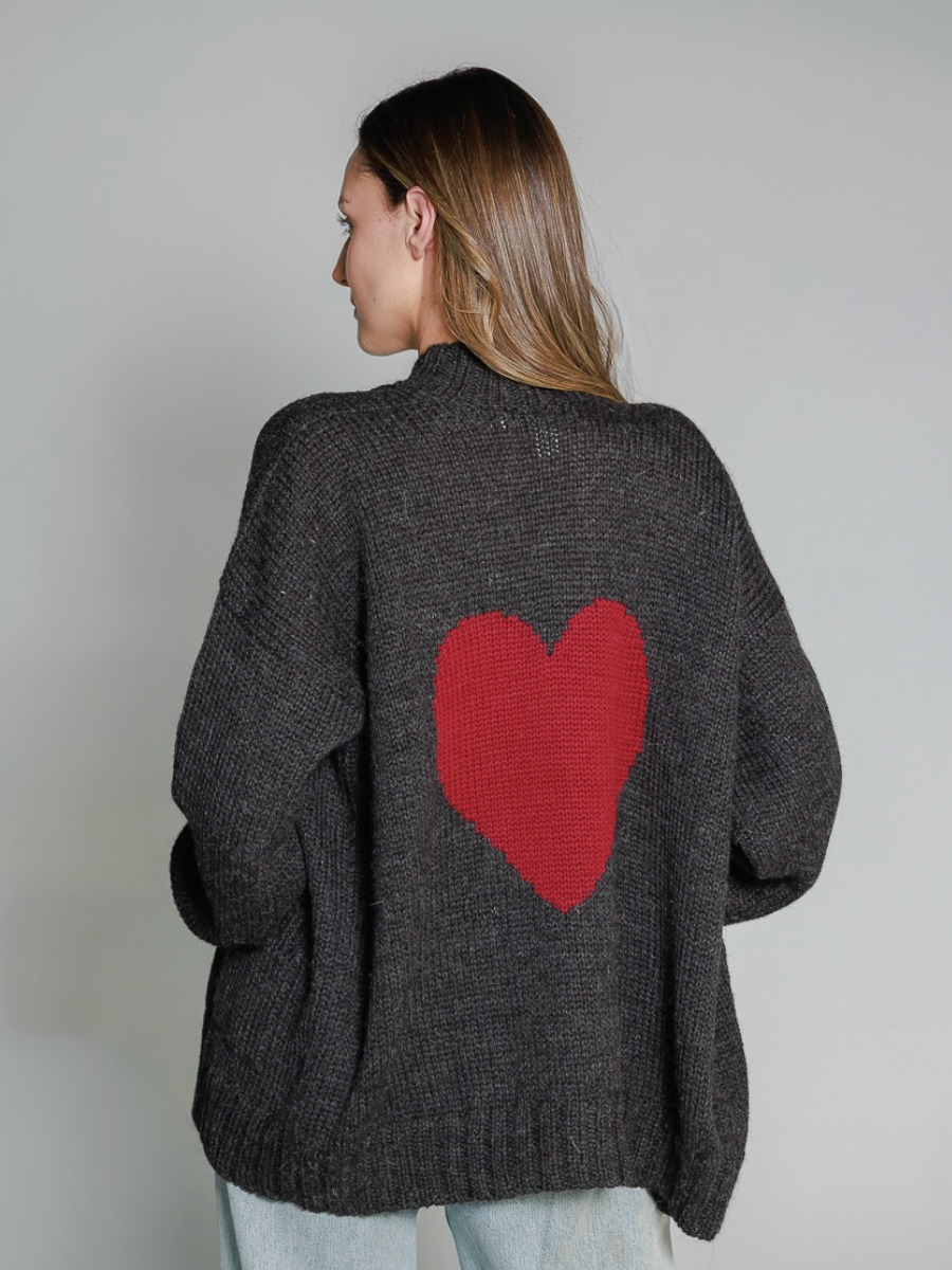 Dark grey alpaca sweater featuring an oversized burgundy heart motif on the back, worn by a model in a white background