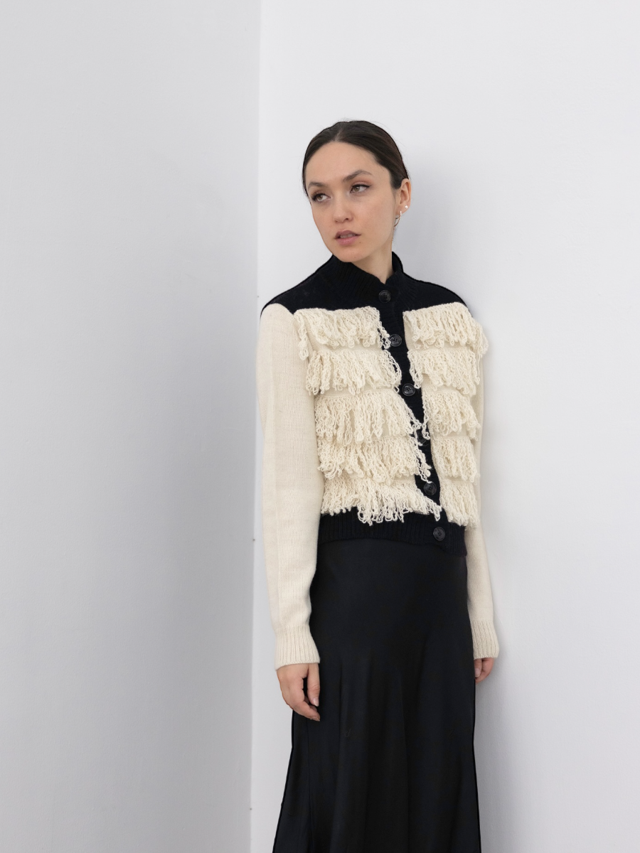 button up alpaca fringed cardigan white with black rib on a model with a white background