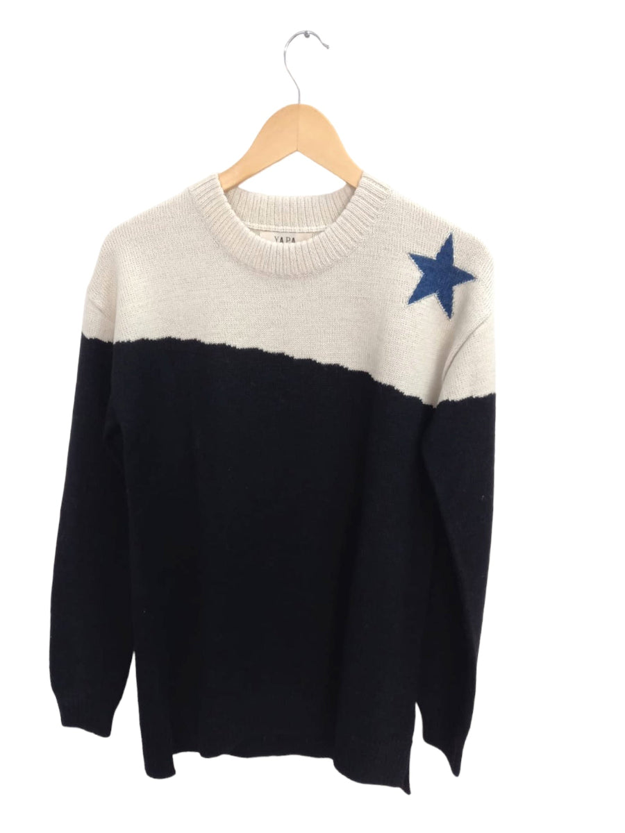 A black and cream alpaca sweater with a blue star detail on the shoulder with a white background