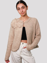 Cargar imagen en el visor de la galería, Woman wearing a beige knitted cardigan with a floral detail, alpaca cardigan 
