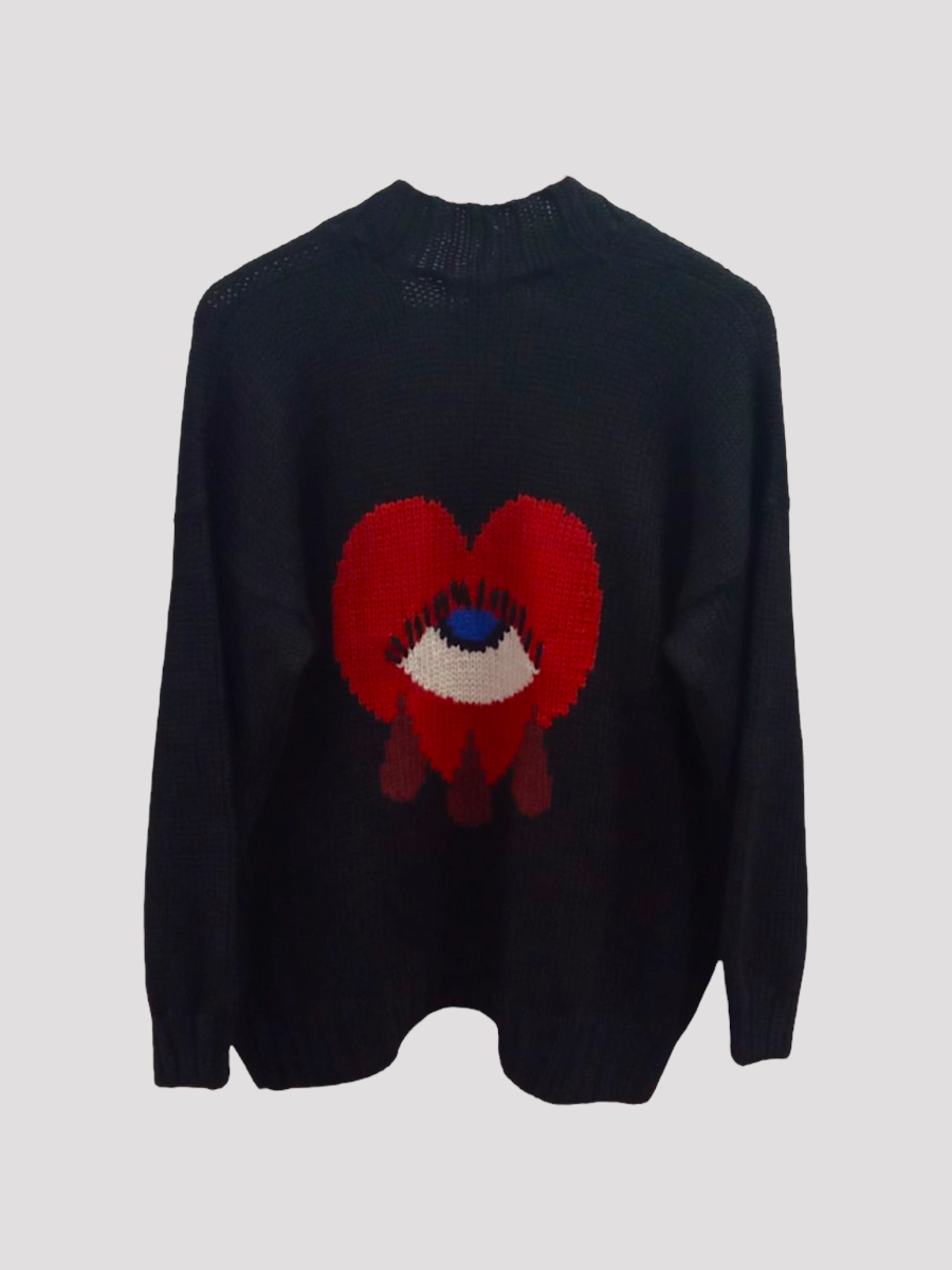 Black alpaca cardigan with a red heart design on a light gray background