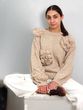 Load image into Gallery viewer, Woman wearing a beige sweater with floral embellishments. best sweaters for fall 2025
