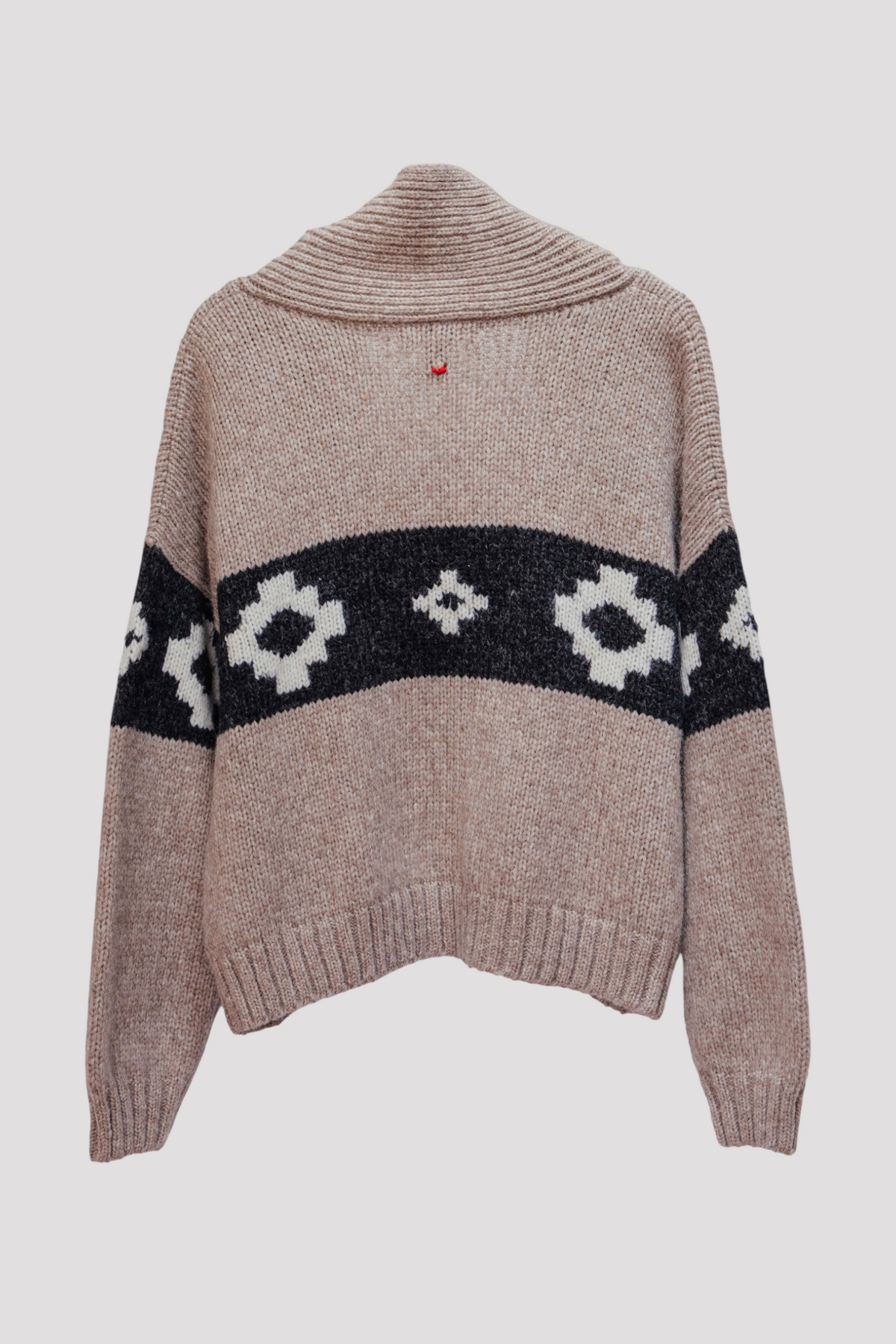 A knit sweater with a high ribbed mock neck, long sleeves, and a horizontal black band across the chest and upper arms featuring white geometric patterns, shown against a light gray background.